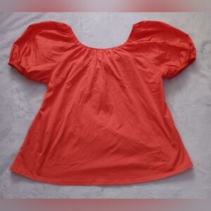 Orange/ coral colored top with puffy sleeves and tie bow in the back